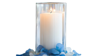 Candle in glass with blue and white flower petals for romantic setting during evening