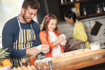 Happy father with little girl having happy moments together in kitchen