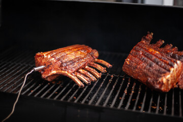 Spare ribs sizzling on the grill with smoky glaze, classic barbecue meat close-up