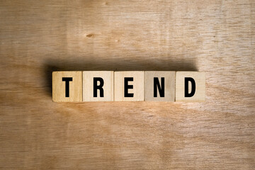 trend words text on wooden blocks on wooden surface