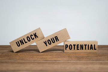 unlock your potential words symbol on wooden blocks isolated on white background. minimalist concept. motivational words