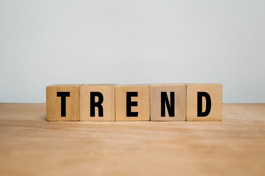 trend words text on wooden blocks on wooden surface