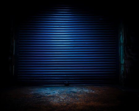 Dark, moody garage door illuminated by a spotlight