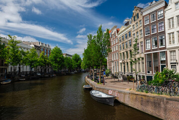 Amsterdam, Netherlands – May 21, 2025: A panoramic view of an Amsterdam canal, bordered by...