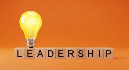 Leadership Lightbulb Bright Idea on Blocks with Orange Background.