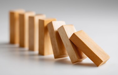 Dominoes cascading in a sequence, symbolizing the effect of a market crash in a minimalist setting