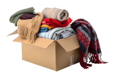 Cardboard box overflowing with warm clothing items PNG Image 
