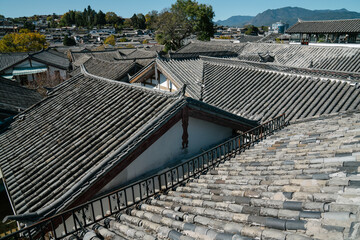 Panoramic view of traditional Chinese rooftops with mountain background on a clear day