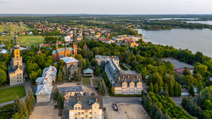 Aerial view of the Sanctuary of Our Lady of Licheń in Licheń Stary, surrounded by monastery buildings and greenery near the lake.