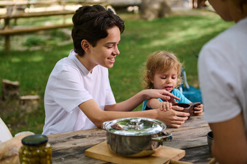Family Enjoying a Relaxing Outdoor Picnic Day at a Park