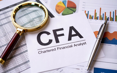 CFA Chartered Financial Analyst Designation with Magnifying Glass, Pen, and Financial Charts