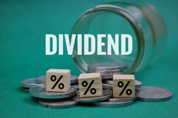 Financial Dividend Concept with Percentage Cube and Coins on Turquoise Background