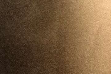 golden spray paint gradient on black color paper