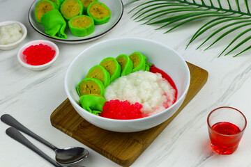 Es Pisang Ijo or Green banana ice, one of Indonesian popular dessert from east Sulawesi, Makassar. Es Pisang ijo made from banana coated with green flour dough, serve with red syrup.