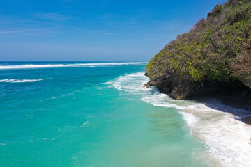 Coastal Cave Beneath Forested Cliff by Turquoise Ocean — Aerial View