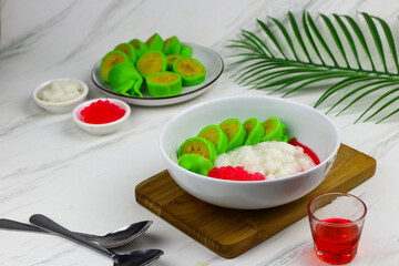 Es Pisang Ijo or Green banana ice, one of Indonesian popular dessert from east Sulawesi, Makassar. Es Pisang ijo made from banana coated with green flour dough, serve with red syrup.