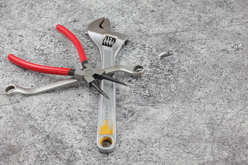  snap ring wrench and spinner pliers scattered on the floor
