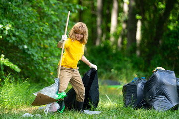 Kid cleaning up the park, putting trash in a garbage bag. Environmental protection. Child Picking...