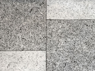 Close up of white and grey terrazzo granite tiles texture. Terrazzo is increasingly being used in contemporary edgy and stylish interior as wall or floor finishing.