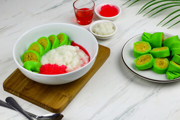 Es Pisang Ijo or Green banana ice, one of Indonesian popular dessert from east Sulawesi, Makassar. Es Pisang ijo made from banana coated with green flour dough, serve with red syrup.