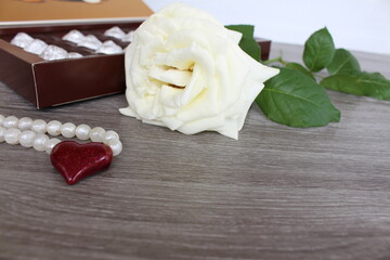 beautiful white rose with a box of chocolates a nice start to the day