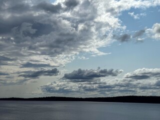 Rain clouds over lake. dramatic blue sky after rain. nature photo of river and thunderclouds....