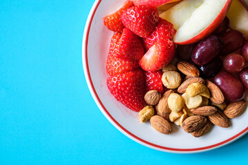 A Plate Of Healthy Fresh Summer Fruit And Mixed Nuts