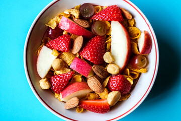 Bowl Of Corn Flakes Breakfast Cereal With Fresh Fruit And Mixed Nuts