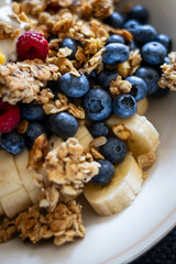Healthy Breakfast Bowl with Granola, Blueberries, Bananas, and Raspberries – Close-Up