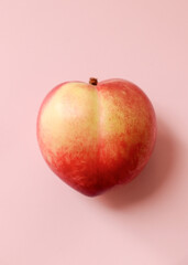Peach(nectarine) on a pink background