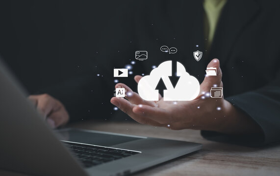 Professional using holographic cloud interface for data synchronization and digital content management, representing secure upload, cloud storage, AI integration, and modern digital workflow. - Powered by Adobe