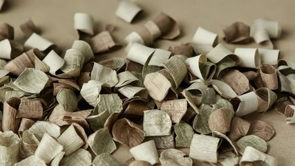 Opening shot showing curled shavings resting on smooth beige surface in soft light - Powered by Adobe