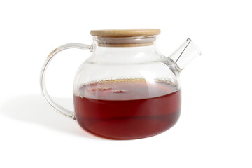 There is a glass teapot with tea on a white background.	