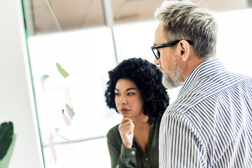 Diverse professionals collaborating on business strategies in a contemporary office environment
