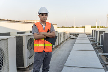 Portrait Asian maintenance engineer works on the roof of factory. contractor inspect compressor...