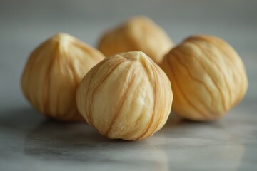 Four hazelnuts. Peeled nuts on light gray background. Healthy snacks