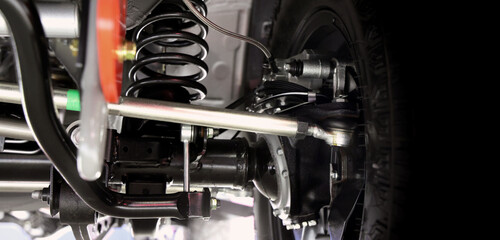 Car suspension part. Close up of a rear car suspension and exhaust system. such as coil springs...