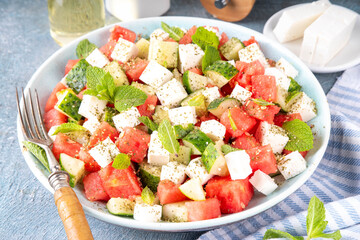 Viral summer Watermelon Salad with slices red watermelon, cucumber, white feta or tofu cheese,...