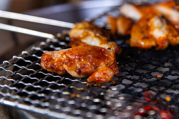 roasting spicy marinated-chicken meat on the charcoal grill