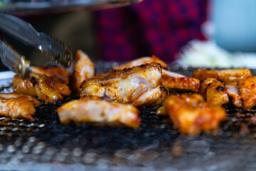 roasting spicy marinated-chicken meat on the charcoal grill