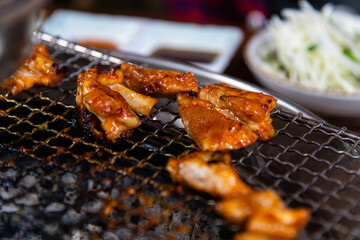 roasting spicy marinated-chicken meat on the charcoal grill