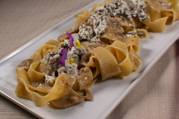 Gourmet Pappardelle with Creamy Sauce, Mushrooms, and Edible Flowers