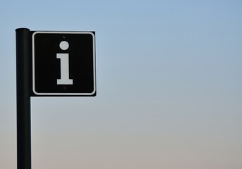 Information sign against sky
