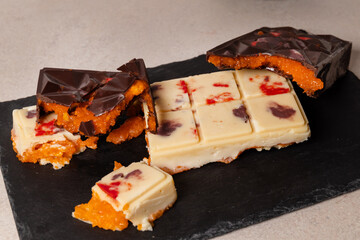 dubai chocolate bar with mango cubes and fresh passion fruit gourmet white chocolate with colorful splashes dessert mango passionfruit concept confectionery