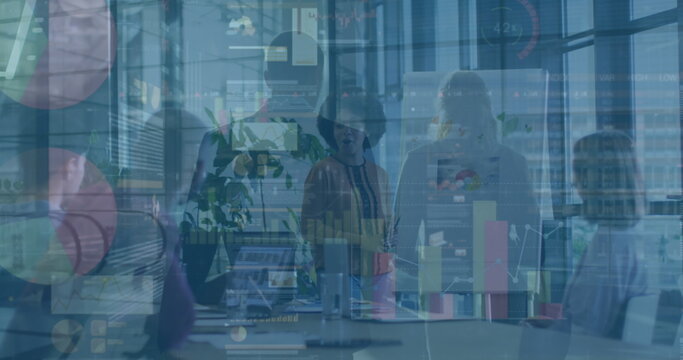 Reviewing data forecasts office team examining charts in conference room, with laptops, flipchart - Powered by Adobe