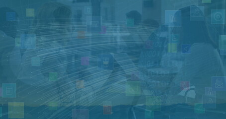 Collaborating business team discussing data at conference table in glass room, with floating icons