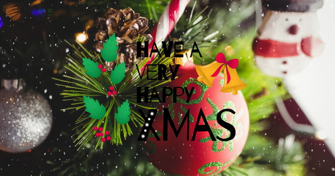 Displaying red bauble hanging on pine branch at home with candy cane snowman ornament text overlay