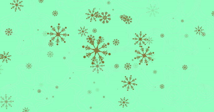 Fototapeta Sparkling gold snowflake motifs covering mint-green background, creating festive abstract pattern