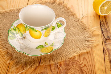 Ceramic cup on a ceramic saucer on a wooden table.