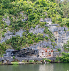 Old waterworks below cliffs on the Lot River near Cahors, France